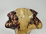 a glass vase with a brown and black design on it