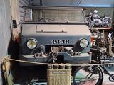 a car and a bike in a garage with a basket on the floor