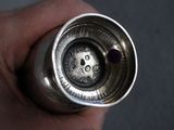 a person holding a silver object in their hand