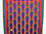 a close up of a purple, green, and orange plaid scarf