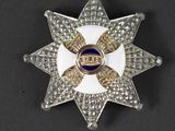 an image of a white and gold star broochle with blue and white stones