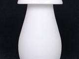a white vase with a white lid on a black background