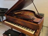 a piano that is sitting in a room with a piano