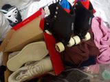many pairs of shoes in a box on a bed