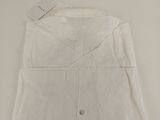 a white shirt on a table with a tag on it