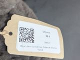 a stuffed elephant with a tag attached to it ' s neck