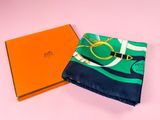 an orange box with a green scarf and a blue and white scarf