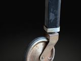 a close up of a metal wheel on a black surface