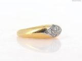 an image of a gold and diamond ring on a white surface