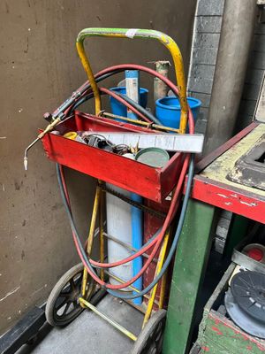 a red cart with a yellow handle next to a green cart with a red handle