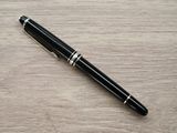an image of a pen laying on a wooden table