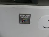 a sticker that says sharp on the side of a refrigerator
