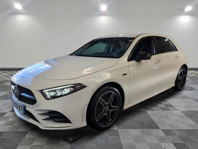 a white mercedes cla parked on a checkered floor
