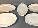 six white plates on a table with a cup of coffee
