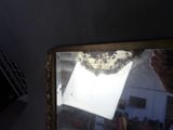 a person taking a picture of a mirror in a room