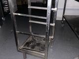 a metal shelf with a metal tray on it in a kitchen