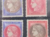 four different postage stamps with heads of women on them