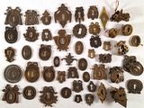 a lot of antique metal items on a white surface