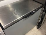 stainless steel counter top in a commercial kitchen with a person standing next to it