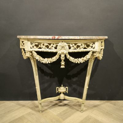 an ornately carved console table with marble top