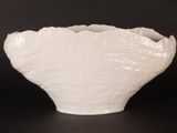a white vase that is sitting on a table