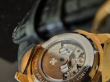 a close up of a watch on a glass table