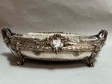 an antique silverplated bowl with handles and handles on a white background