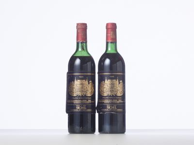 two bottles of wine sitting on top of a white table