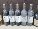 several bottles of wine are lined up in a row on a table