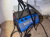 a blue and black welding machine sitting on the floor