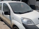 a small white van parked on the side of the road