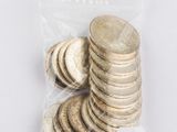 a bag of coins sitting on top of a table