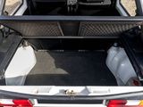 a car with its trunk open on the side of the road