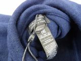 the label of a blue jacket is attached to the back of the jacket