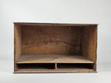 an old wooden box with two open compartments sitting on a white surface