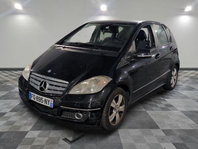 a picture of a black mercedes b - class parked in a garage