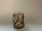 a close up of a stone object on a white surface