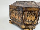 a gold and black box sitting on a white surface