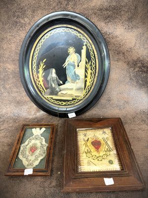 two framed pictures of jesus and mary on the wall