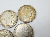 six different british coins are shown on a white surface