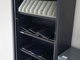 a black bookcase with a bunch of books in it