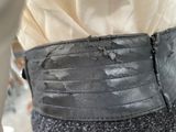 a close up of a black belt on a person ' s waist