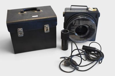 a black box with a fan and a black box with a power cord