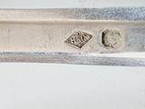an old silver plate with a silver handle and a silver plate with a silver handle and a silver plate with a silver handle and a silver plate with a silver handle