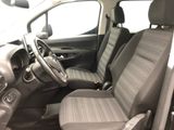 the interior of a small car with a steering wheel and a dashboard
