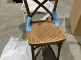 a wooden chair that has been painted with blue tape