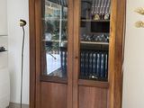 a wooden cabinet with a glass door in a room