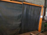 an image of a room that has a black curtain on the wall