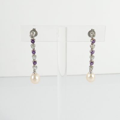 a pair of earrings with pearls and amethorate