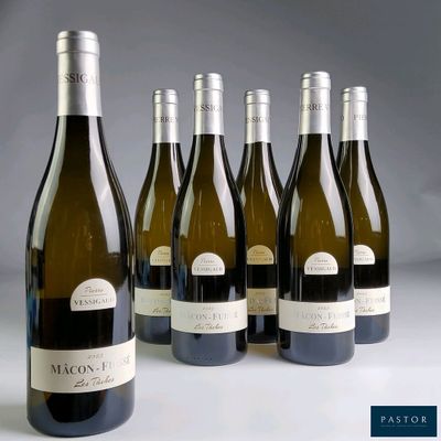 six bottles of wine are lined up in a row on a table
